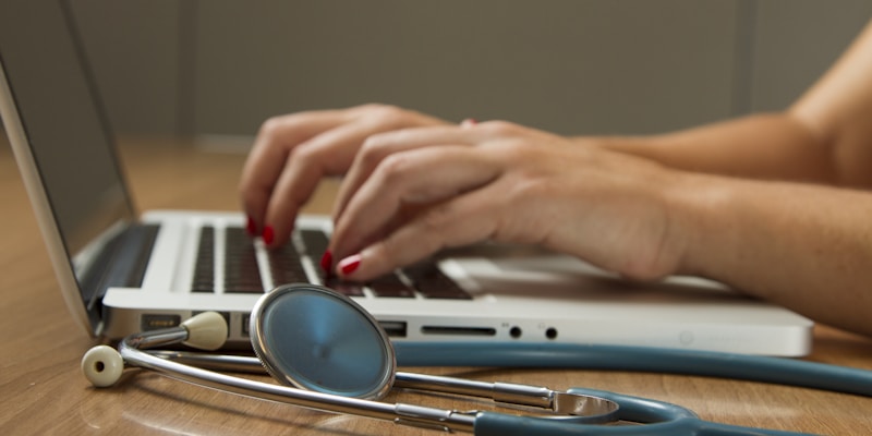 Person reviewing prescription costs and savings on a laptop