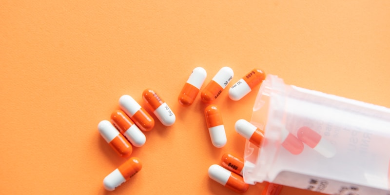 Pharmacist organizing prescription medications on pharmacy shelves