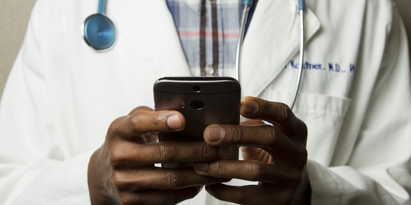 Healthcare professional reviewing prescription costs on a tablet in a clinical setting